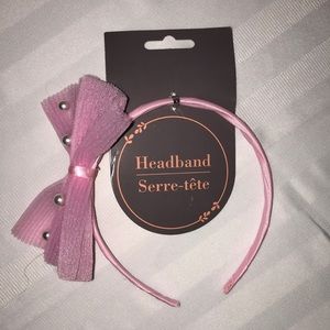 Girl headband with pink ribbon and pearls.